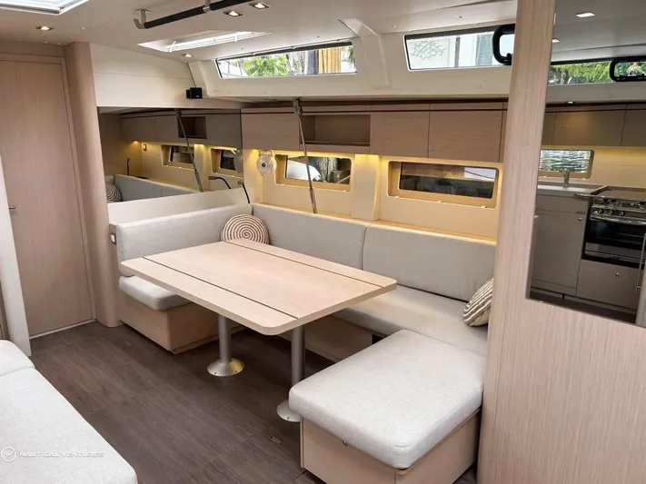  Yacht Photos Pics Luxurious interior of 2024 Beneteau Oceanis 51.1 yacht with modern dining area.
