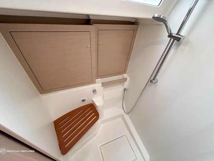  Yacht Photos Pics 2024 Beneteau Oceanis 51.1 yacht bathroom with wooden seat and modern shower.