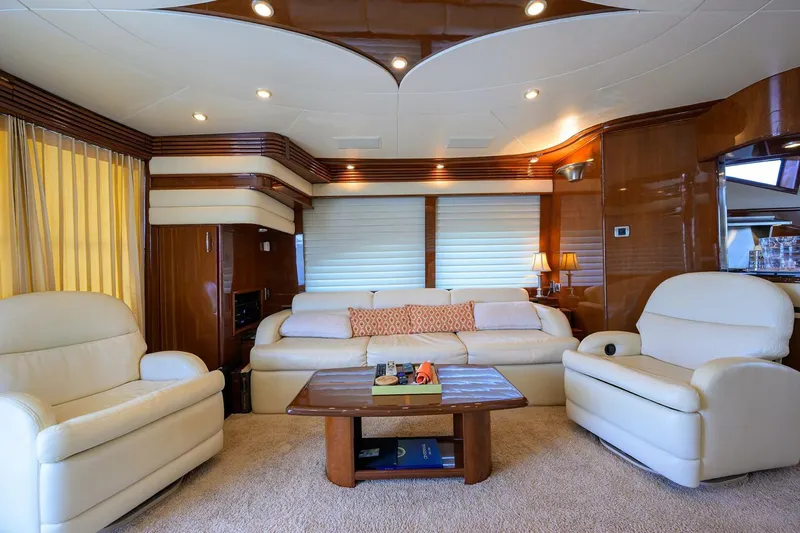 Vol Aboard Yacht Photos Pics Luxurious interior of a 2005 Marquis 65 MY yacht with plush seating and elegant decor.