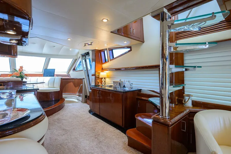 Vol Aboard Yacht Photos Pics Luxurious interior of a 2005 Marquis 65 MY yacht with elegant wood finishes and modern design.