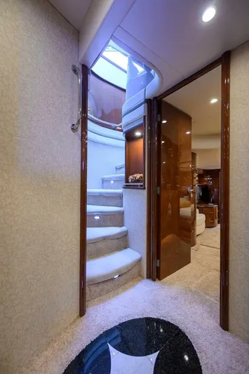 Vol Aboard Yacht Photos Pics Interior of 2005 Marquis 65 MY yacht with elegant staircase and luxurious cabin.