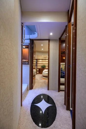 Vol Aboard Yacht Photos Pics Luxurious interior hallway of a 2005 Marquis 65 MY yacht, featuring elegant design elements.