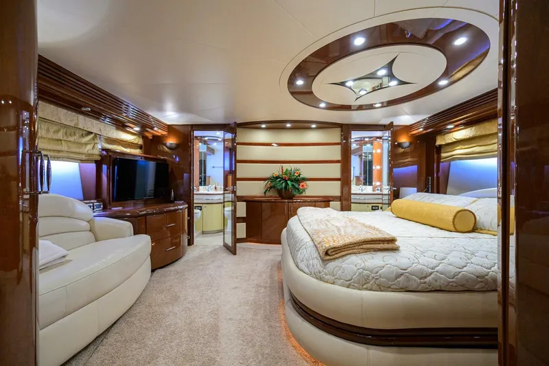 Vol Aboard Yacht Photos Pics Luxurious interior of a 2005 Marquis 65 MY yacht bedroom with elegant furnishings.