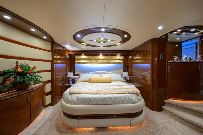 Vol Aboard Yacht Photos Pics Luxurious bedroom interior of 2005 Marquis 65 MY yacht with elegant wood finishes.