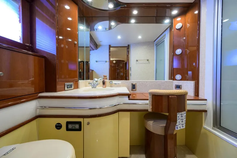 Vol Aboard Yacht Photos Pics Luxurious bathroom interior of a 2005 Marquis 65 MY yacht, featuring elegant wood finishes.