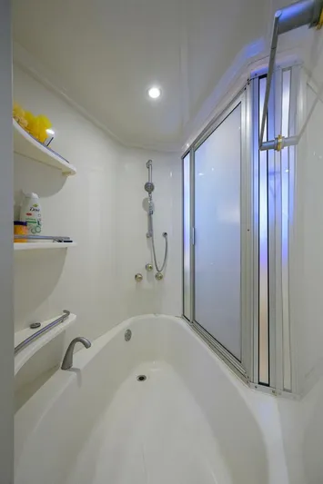 Vol Aboard Yacht Photos Pics Luxurious bathroom in 2005 Marquis 65 MY yacht with modern fixtures and shelving.