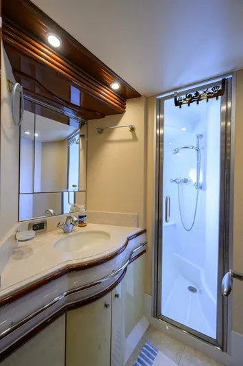 Vol Aboard Yacht Photos Pics Luxurious bathroom in 2005 Marquis 65 MY yacht with elegant fixtures and modern shower.