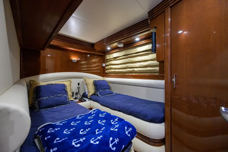 Vol Aboard Yacht Photos Pics Luxurious cabin interior of 2005 Marquis 65 MY yacht with twin beds and nautical decor.