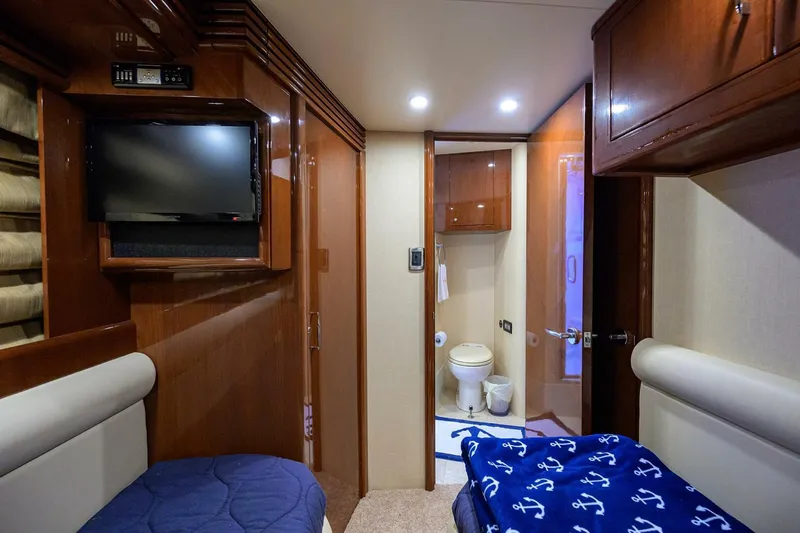 Vol Aboard Yacht Photos Pics Luxurious 2005 Marquis 65 MY yacht cabin with TV, bed, and ensuite bathroom.