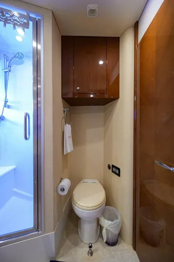 Vol Aboard Yacht Photos Pics Luxurious bathroom in 2005 Marquis 65 MY yacht with shower and wooden cabinetry.