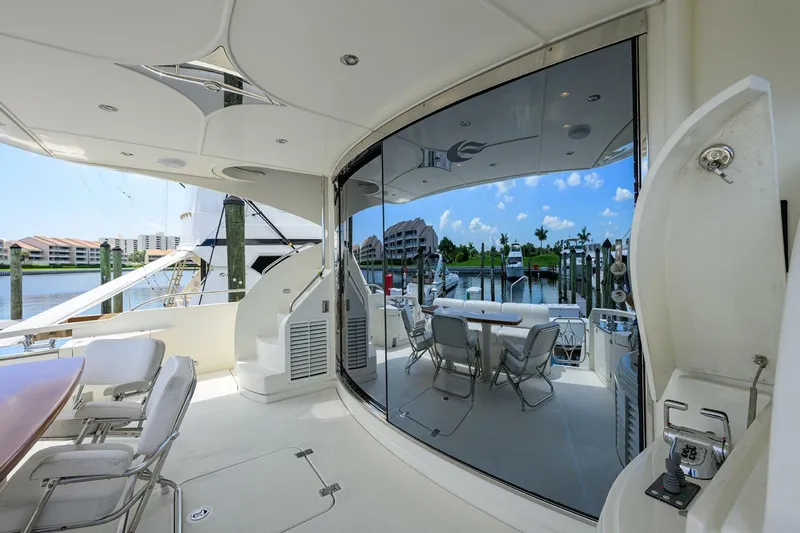 Vol Aboard Yacht Photos Pics Luxurious 2005 Marquis 65 MY yacht interior with marina view and elegant seating area.