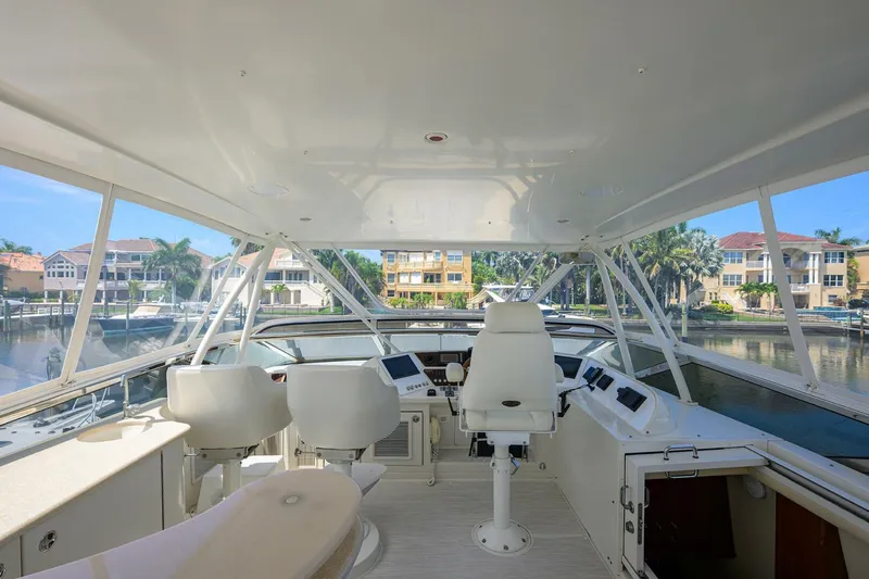 Vol Aboard Yacht Photos Pics Cockpit view of 2005 Marquis 65 MY yacht with modern seating and controls.