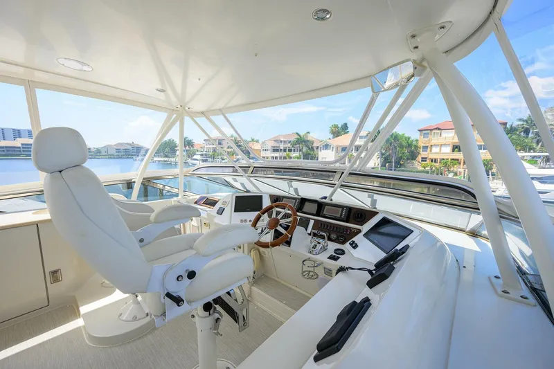 Vol Aboard Yacht Photos Pics Luxurious 2005 Marquis 65 MY yacht helm with modern controls and panoramic views.