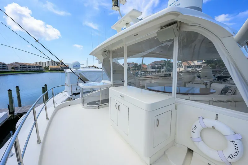 Vol Aboard Yacht Photos Pics Luxurious 2005 Marquis 65 MY yacht deck with seating and scenic marina view.