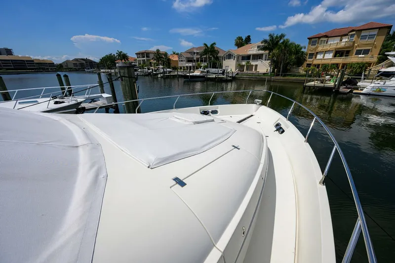 Vol Aboard Yacht Photos Pics Luxury 2005 Marquis 65 MY yacht docked in scenic waterfront marina.