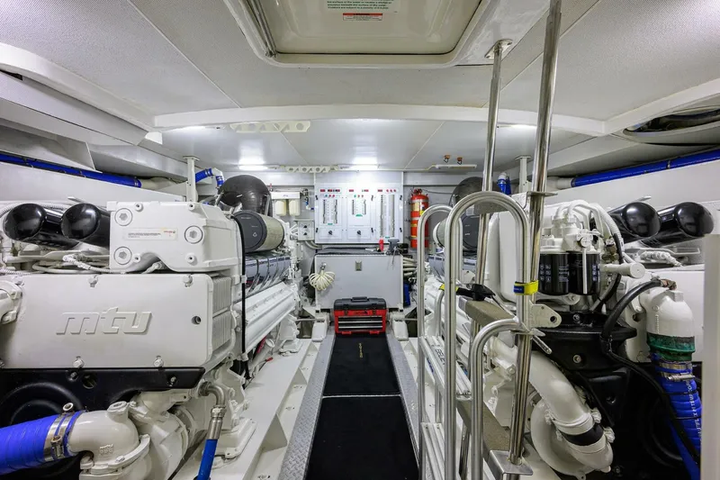 Vol Aboard Yacht Photos Pics Engine room of a 2005 Marquis 65 MY yacht, featuring MTU engines and control panels.