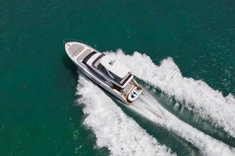 Macu Yacht Photos Pics 2024 Ferretti Yachts 580 cruising on open water, aerial view.