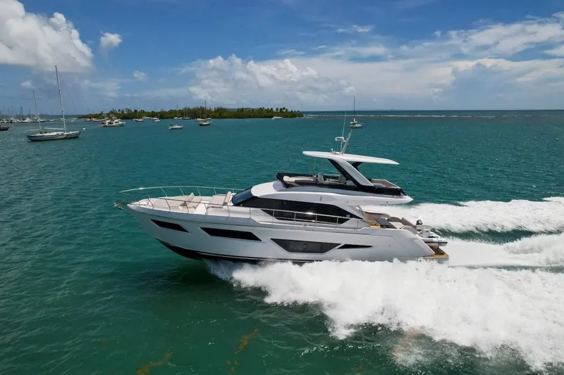 Macu Yacht Photos Pics 2024 Ferretti Yachts 580 cruising on turquoise waters under a clear blue sky.