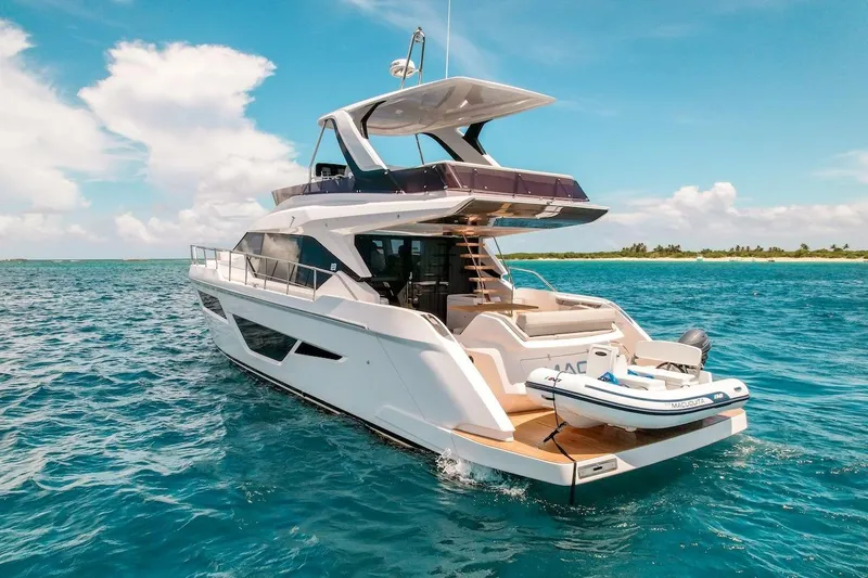 Macu Yacht Photos Pics 2024 Ferretti Yachts 580 cruising on clear blue ocean near tropical island.