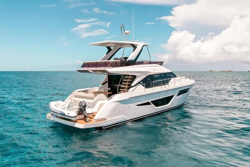 Macu Yacht Photos Pics 2024 Ferretti Yachts 580 cruising on clear blue ocean under a bright sky.