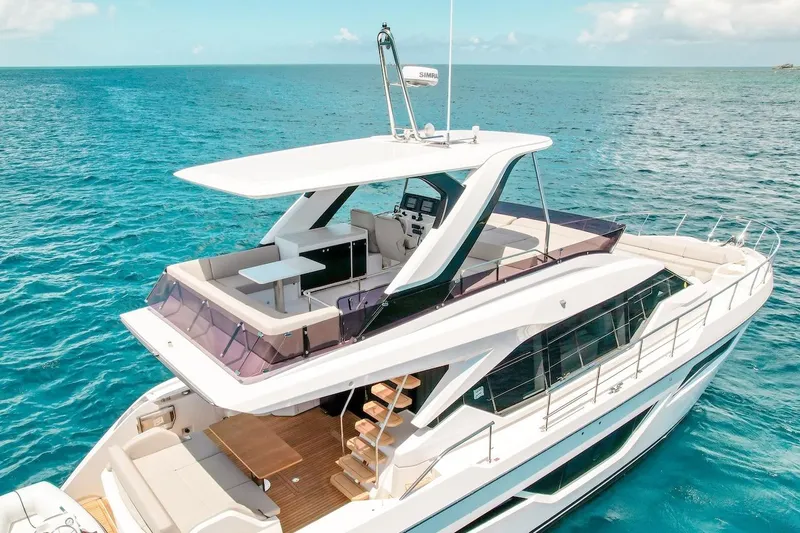 Macu Yacht Photos Pics Luxurious 2024 Ferretti Yachts 580 cruising on clear blue ocean waters.
