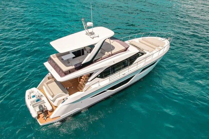 Macu Yacht Photos Pics 2024 Ferretti Yachts 580 cruising on clear blue water.