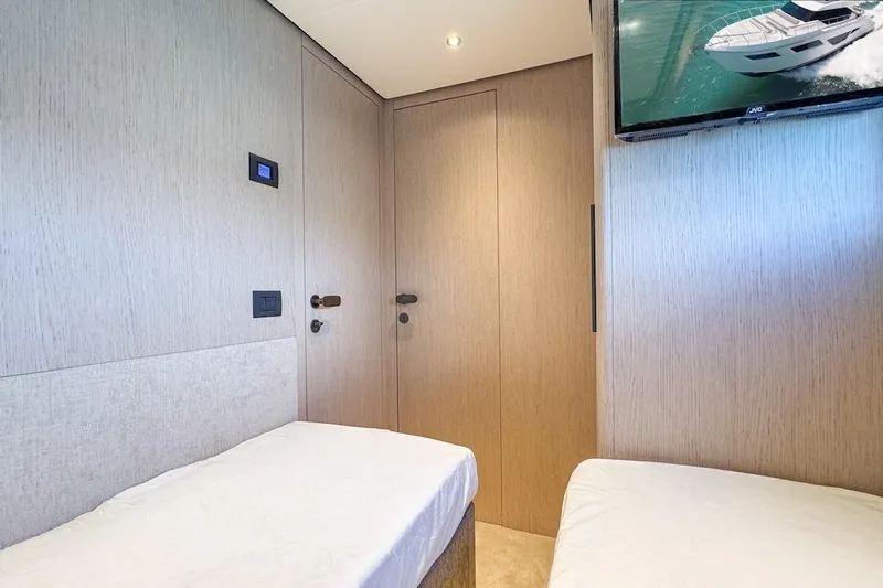 Macu Yacht Photos Pics Interior of 2024 Ferretti Yachts 580 cabin with twin beds and wall-mounted TV.