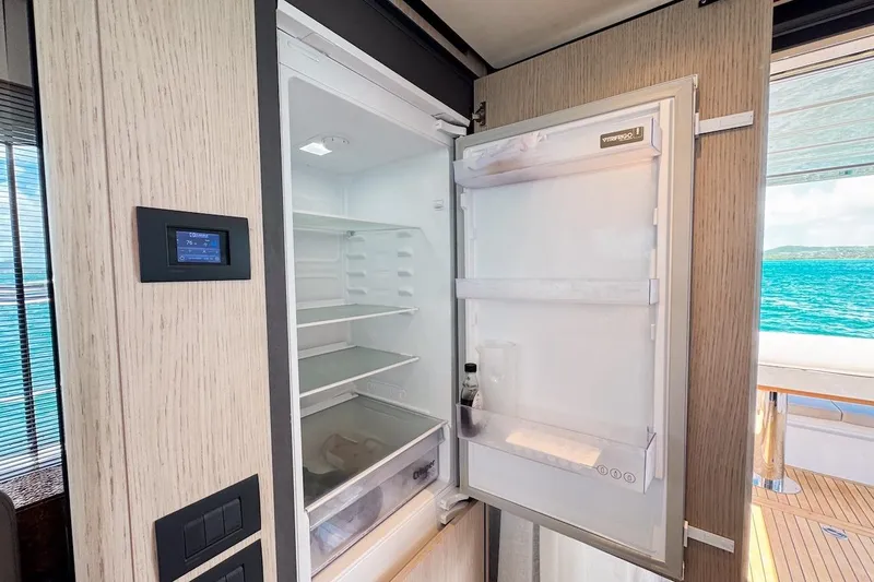 Macu Yacht Photos Pics Open refrigerator on 2024 Ferretti Yachts 580, showcasing modern interior and ocean view.