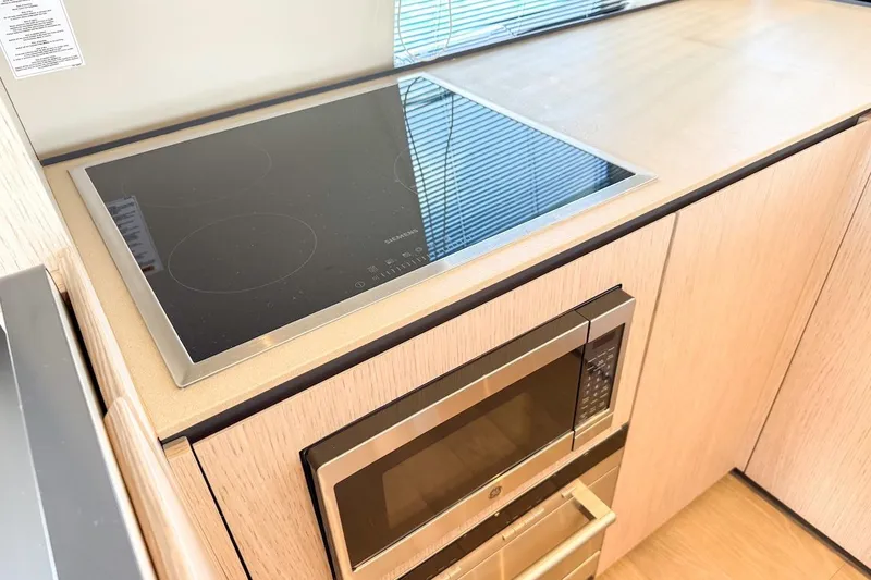 Macu Yacht Photos Pics Modern kitchen in 2024 Ferretti Yachts 580 with sleek cooktop and microwave.