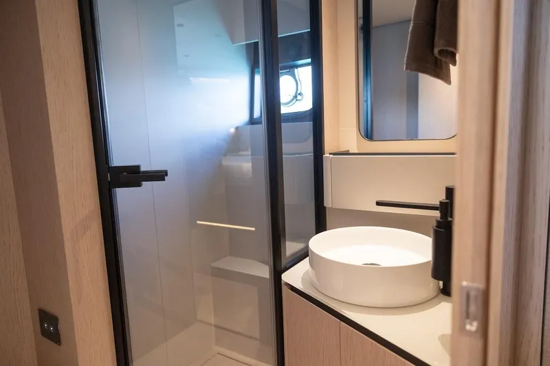 Macu Yacht Photos Pics Luxurious bathroom interior of 2024 Ferretti Yachts 580, featuring modern sink and shower.