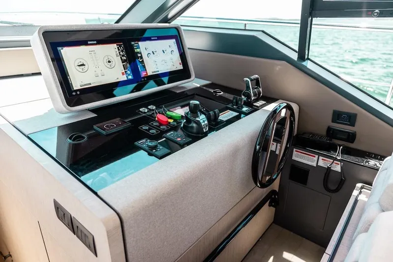 Macu Yacht Photos Pics 2024 Ferretti Yachts 580 helm with advanced navigation controls and dual display screens.