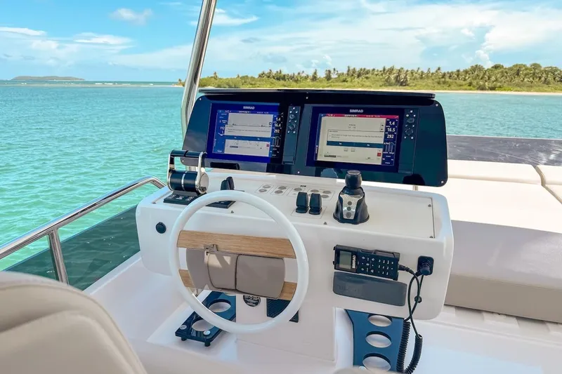 Macu Yacht Photos Pics Helm of 2024 Ferretti Yachts 580 with dual navigation screens, overlooking serene waters.