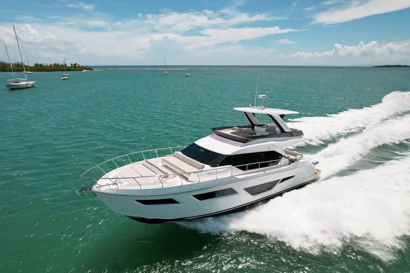 Macu Yacht Photos Pics 2024 Ferretti Yachts 580 cruising on turquoise waters under a clear blue sky.