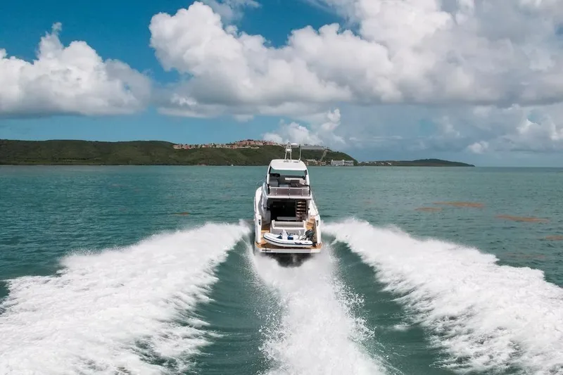 Macu Yacht Photos Pics 2024 Ferretti Yachts 580 cruising on open water under a cloudy sky.