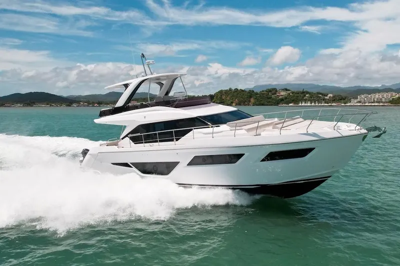 Macu Yacht Photos Pics 2024 Ferretti Yachts 580 cruising on turquoise waters under a clear blue sky.