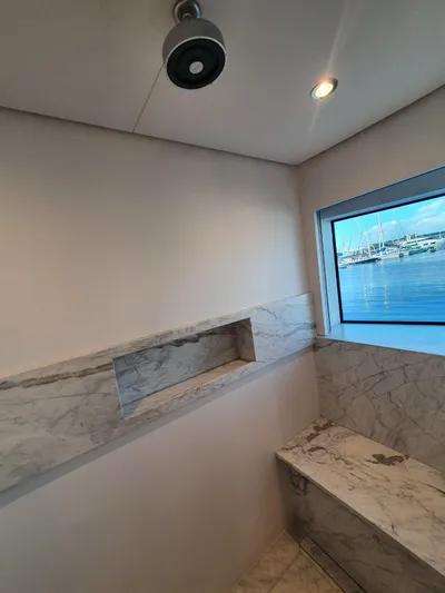  Yacht Photos Pics Luxurious marble bathroom in 2027 Inace Explora 90 yacht with ocean view.