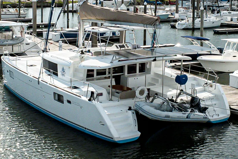  Yacht Photos Pics 2012 Lagoon 450 F catamaran docked at marina with inflatable boat attached.