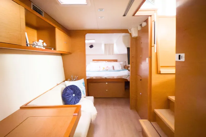  Yacht Photos Pics Interior of 2012 Lagoon 450 F yacht, featuring cozy cabin and wooden furnishings.
