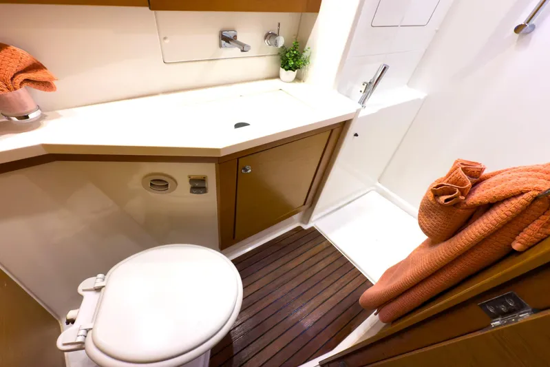  Yacht Photos Pics Luxurious bathroom in 2012 Lagoon 450 F yacht with modern fixtures and orange towels.