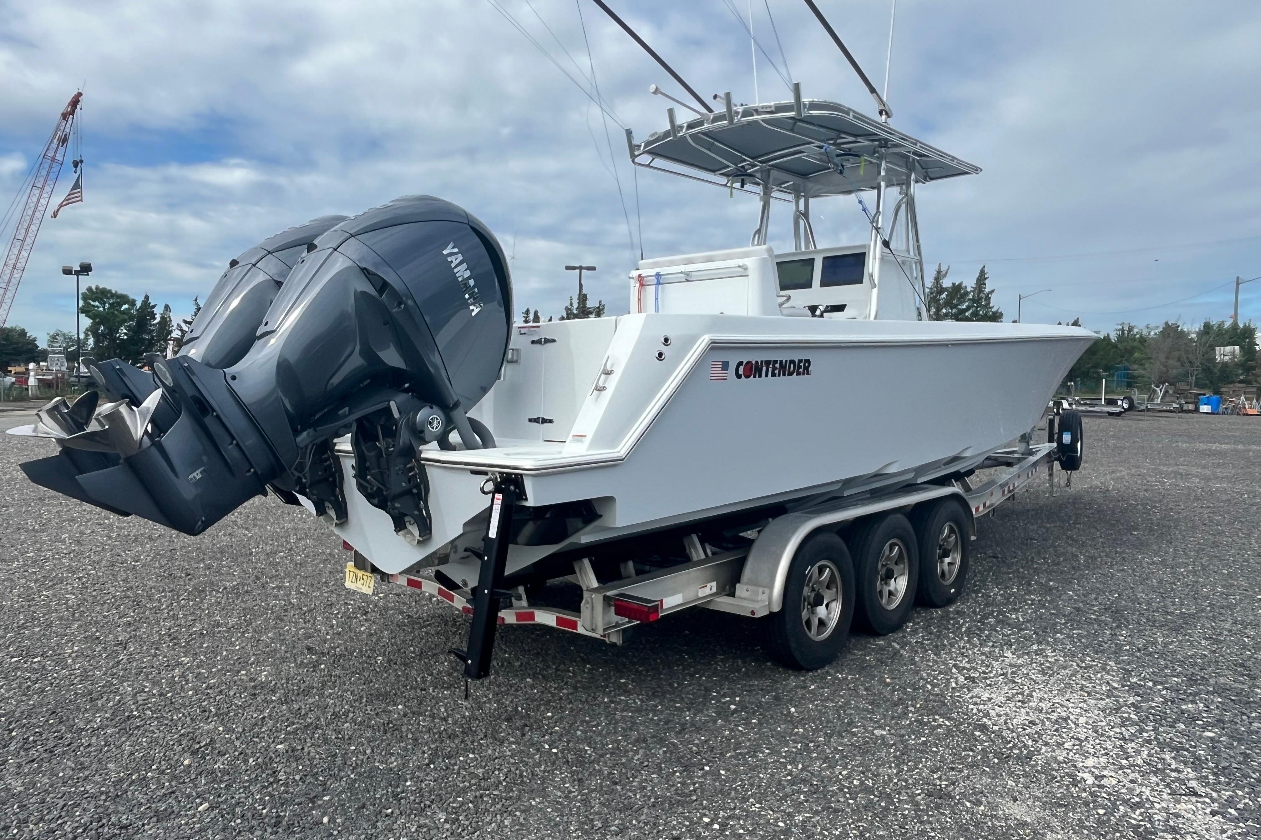 2022 Contender 32 ST boat on trailer with dual Yamaha outboard engines.