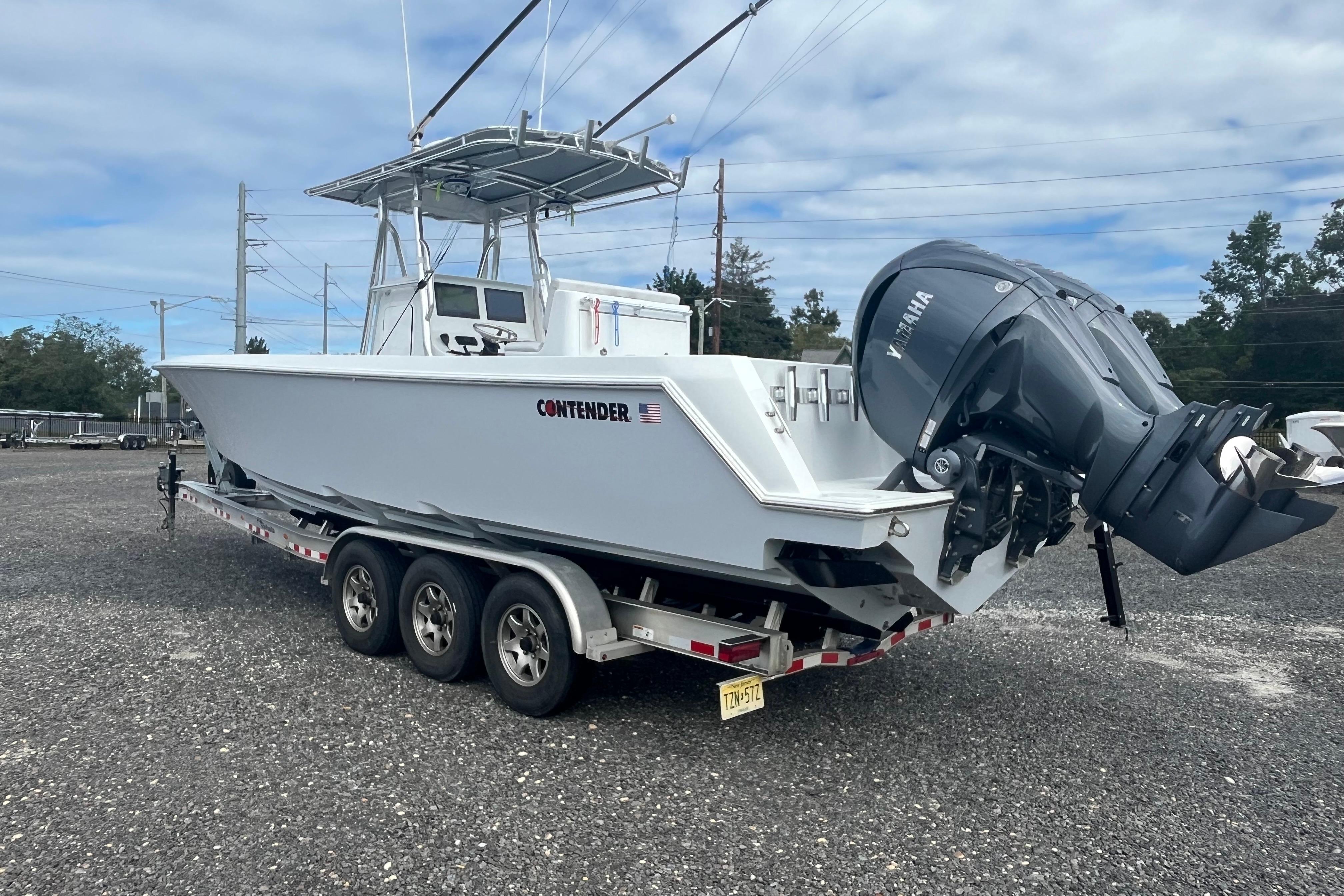 2022 Contender 32 ST boat on trailer with Yamaha outboard engines.