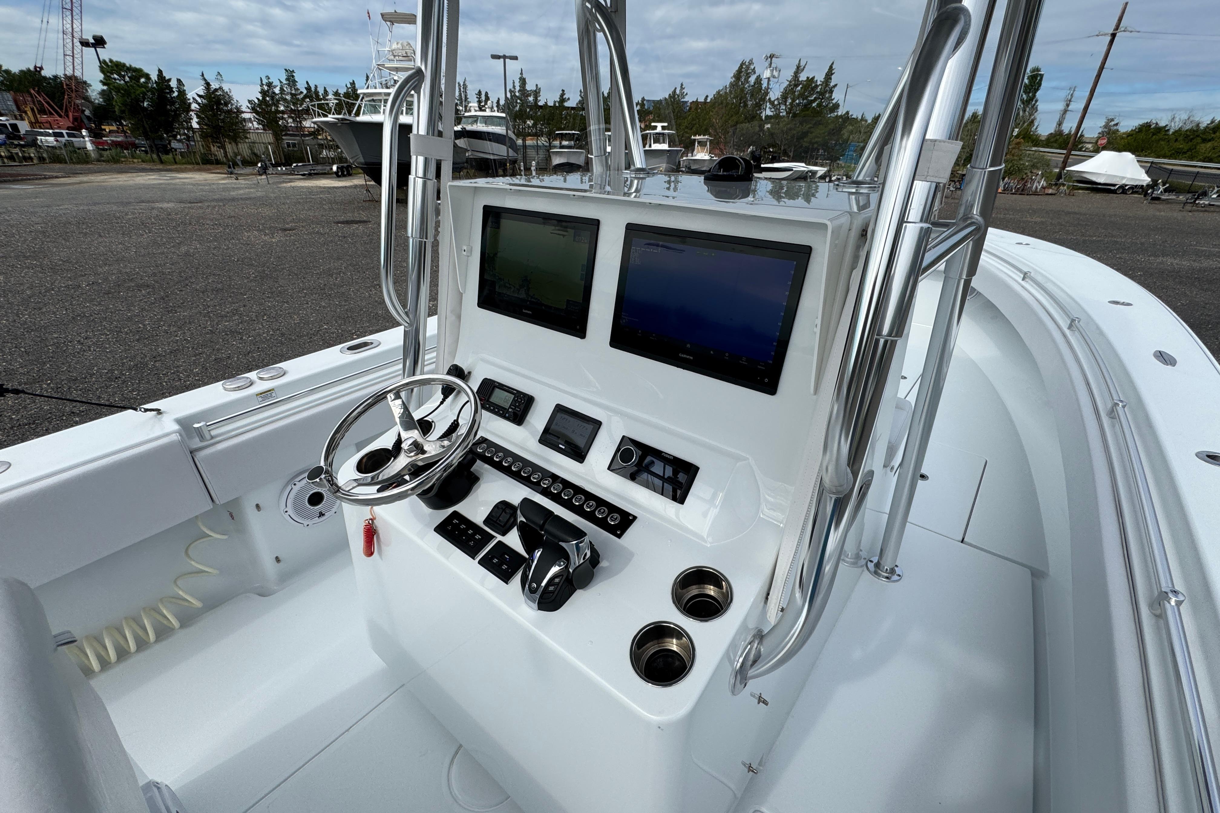 2022 Contender 32 ST boat console with steering wheel and navigation screens.
