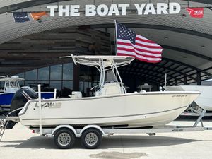 2020 Mako 214 CC boat on trailer at The Boat Yard, American flag displayed.