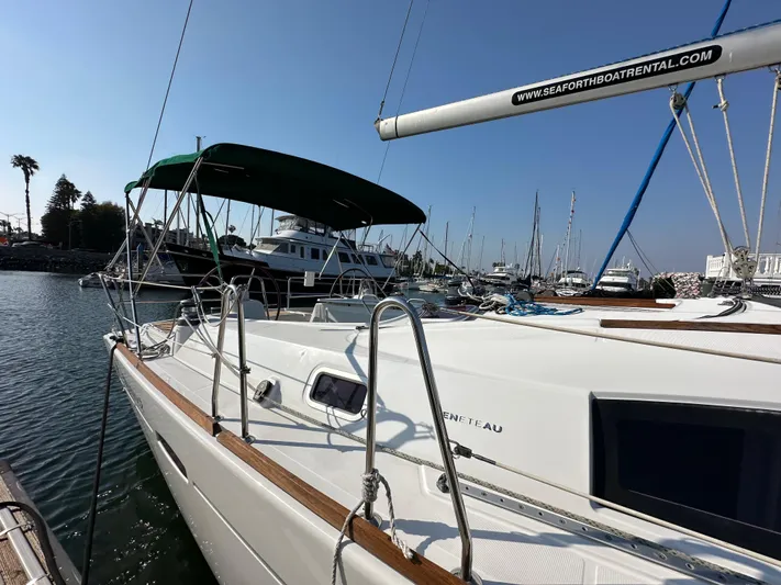 Shamrock Yacht Photos Pics Sailboat Beneteau Oceanis 40, 2011 model, docked in a marina under clear skies.