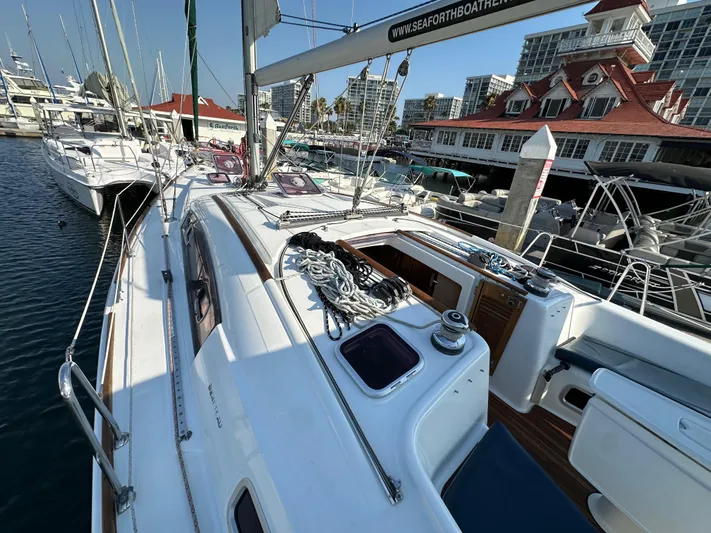 Shamrock Yacht Photos Pics Beneteau Oceanis 40 sailboat, 2011 model, docked at marina with cityscape background.