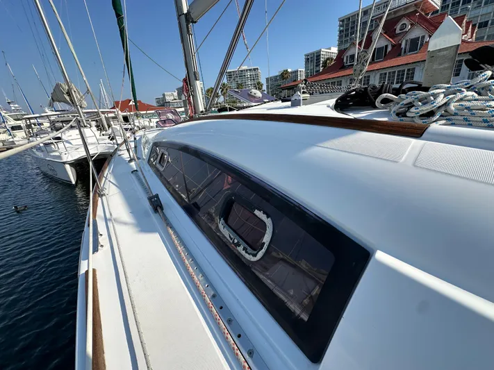 Shamrock Yacht Photos Pics Beneteau Oceanis 40 sailboat, 2011 model, docked at marina with cityscape background.