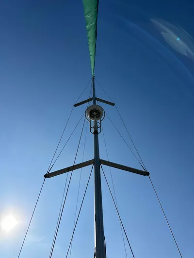 Shamrock Yacht Photos Pics Mast of 2011 Beneteau Oceanis 40 sailboat against clear blue sky.
