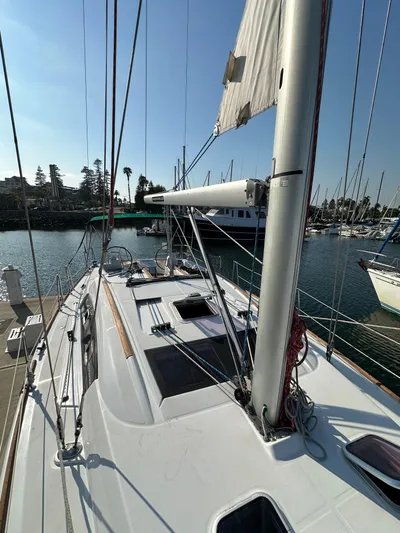 Shamrock Yacht Photos Pics 2011 Beneteau Oceanis 40 sailboat docked in a sunny marina.