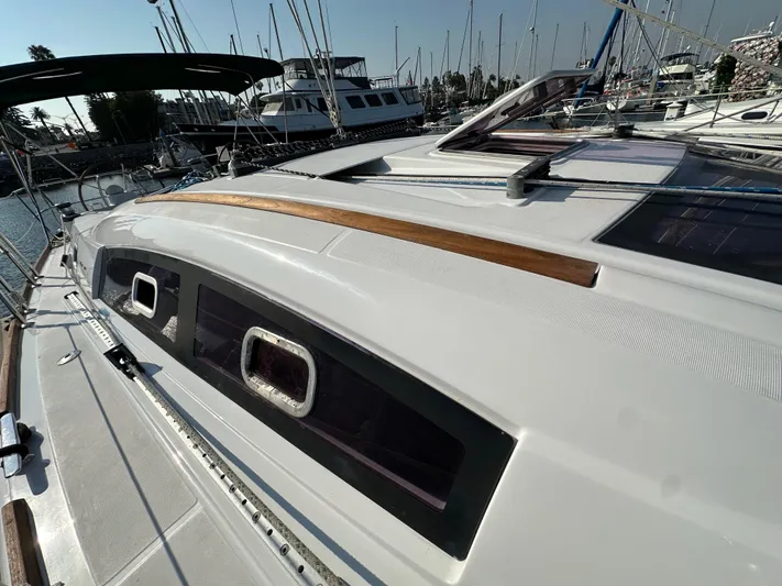 Shamrock Yacht Photos Pics 2011 Beneteau Oceanis 40 sailboat deck with sleek design in marina setting.