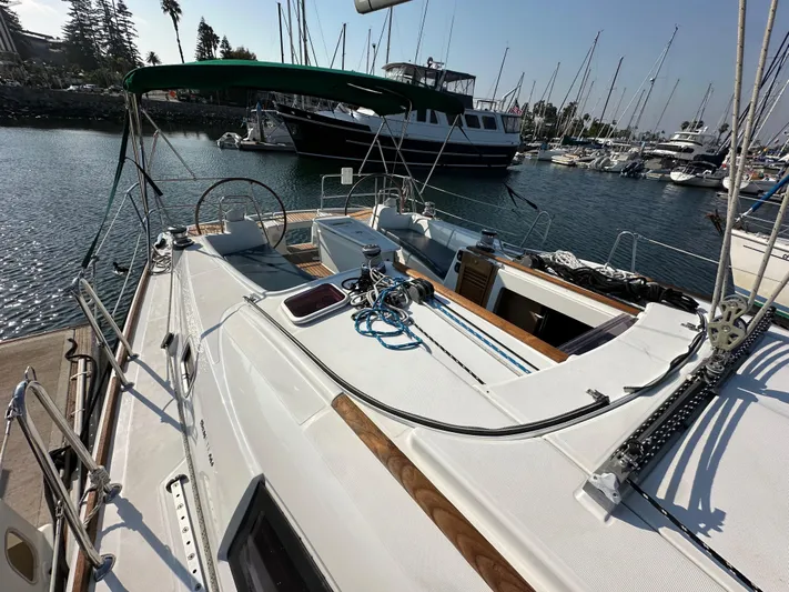 Shamrock Yacht Photos Pics 2011 Beneteau Oceanis 40 sailboat docked in marina, showcasing deck and steering wheel.